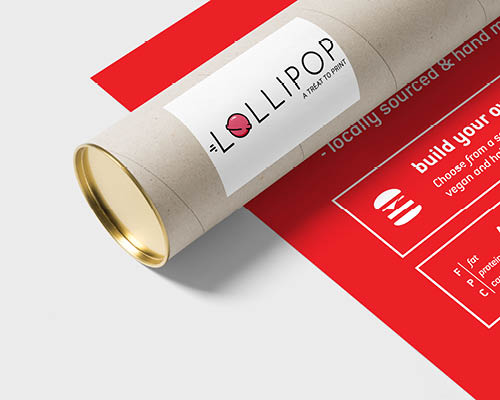 Postal tube laying on a printed poster with a grey background